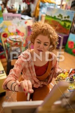 Top view of artist wearing bracelet painting on canvas Stock Photos