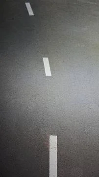Top view of asphalt road with dashed white dividing line Stock Photos