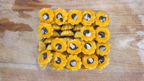 Top view of assorted bite size pastries in clear plastic tray on a rustic w.. Stock Photos