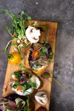 Top view assorted bruschetta with different flavors on a wooden board Stock Photos