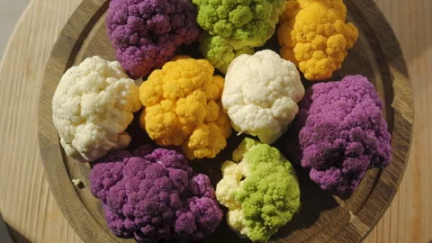 Top view of assorted cauliflower florets on wooden serving board Stock Footage 346040232