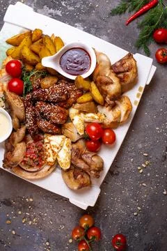 Top view of assorted different chicken dishes on a white plate Stock Photos