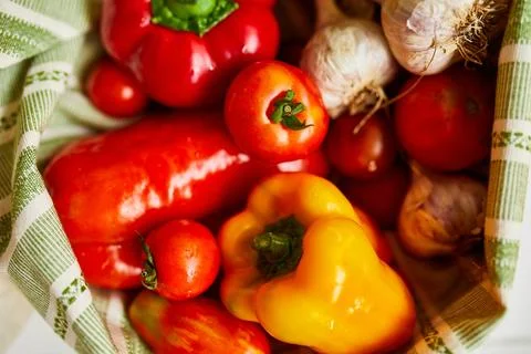 Top view assorted fresh vegetables in reusable cotton bags on table in the ki Stock Photos