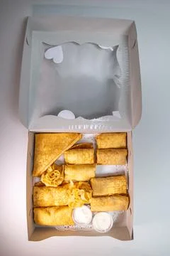 Top view assorted pancakes with various fillings in a white package Stock Photos