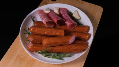 Top view of assorted sausages rotating on board Stock Footage 346801835