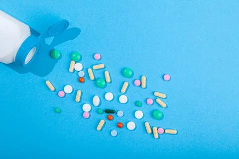 Top view of assorted scattered from pill bottle colorful tablets and capsules Stock Photos
