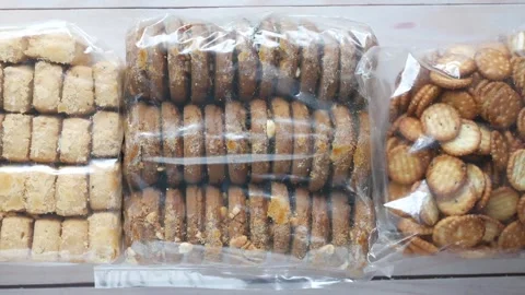 Top view of assorted sweet and salty cookies in plastic packaging on wooden.. Stock Footage 333029849
