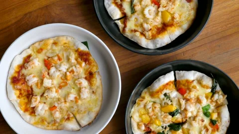 Top View of Assortment of Small Pizzas in Plates on Wooden Background Stock Footage 157955754