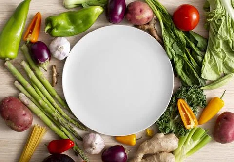Top view assortment veggies with empty plate. High quality and resolution b.. Stock Photos