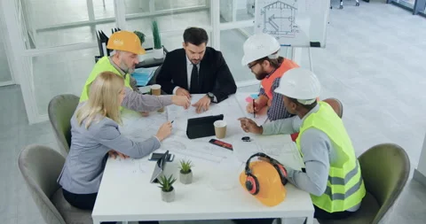 Top view of attractive skilled professional diverse team of engineers and their Stock Footage 145601575