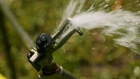 Top view of Automatic Lawn Sprinkler on the Garden in Slow Motion Stock-Footage 129090766