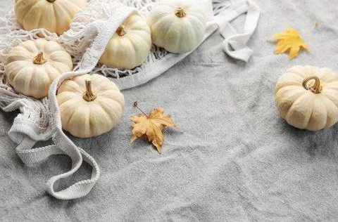 Top view autumn composition with pumpkins in mesh shopping bag Stock Photos