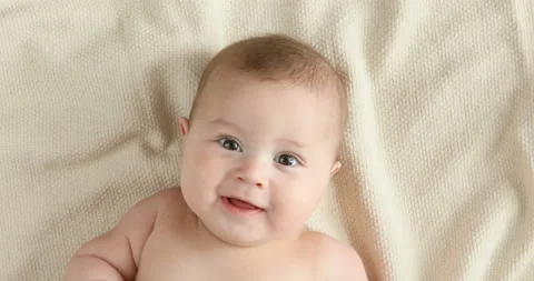 Top view of the baby looking in the camera and smiling, close up 4k shot. 스톡 동영상 126495742