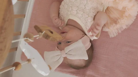 Top view of baby looking at mobile Stock Footage 227379765