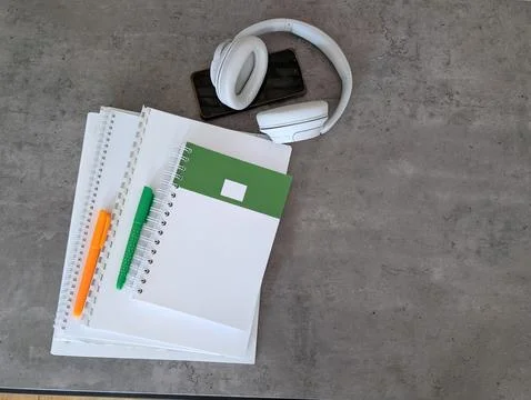 Top view back to school workspace featuring stacked white spiral notebooks Stock Photos