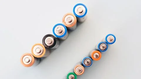 Top view Background from AA and mini batteries for devices. Alkaline batterie Stock Photos