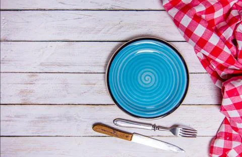 Top view background with empty blue ceramic plate, antique silver cutlery on Stock Photos