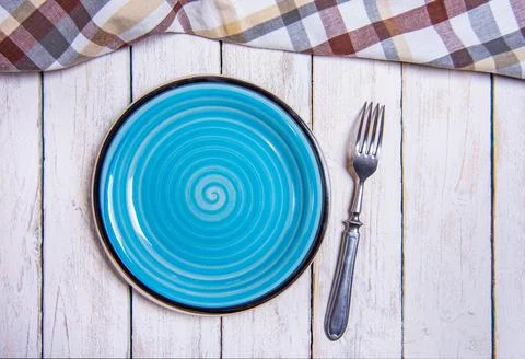 Top view background with empty blue ceramic plate, antique silver cutlery on Stock Photos