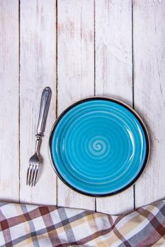 Top view background with empty blue ceramic plate, antique silver cutlery on Stock Photos