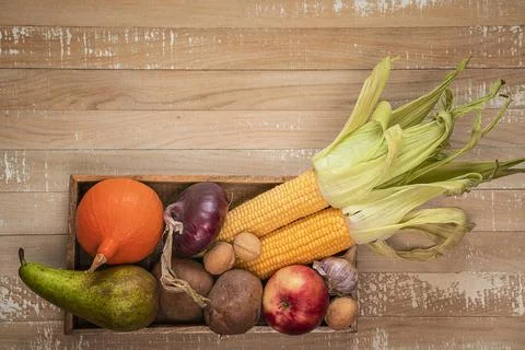 Top view background of organic vegetables and fruits at the box. Stock Photos