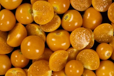 Top view background pattern of ripe physalis berries cut in half Stock Photos