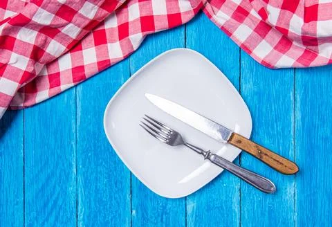 Top view background with squared empty white ceramic plate on vintage weathered Stock Photos