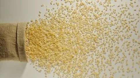 TOP VIEW: Bag falls and pasta letters are poured out of it - Slow Motion Vídeo Stock 98666315
