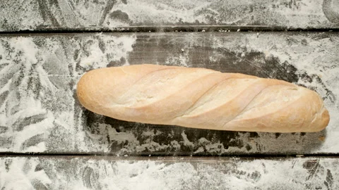TOP VIEW: Baguette Falling Down On A Black Surface with a flour Stock Footage 167990701