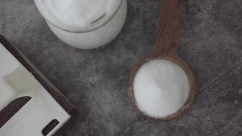 Top view of baking soda powder on a black background for cleaning Stock Footage 335499336