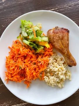 Top view of balanced meal with bulgur chicken carrot salad and green salad .. Stock Photos