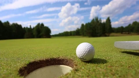 Top view, the ball rolls into the hole, the man plays golf Video stock 169012380
