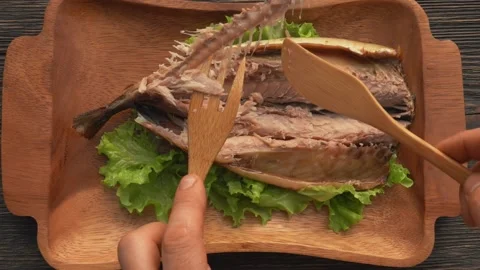 Top view of the bamboo fork takes a spine from delicious grilled Mackerel fish Stock Footage 169813537