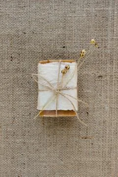 Top view on bar of handmade natural soap or dry shampoo with flax flower on Stock Photos