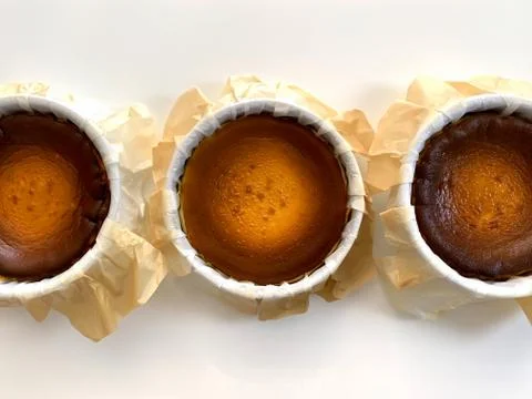 Top view of Basque burnt cheesecake on white background. Stock Photos