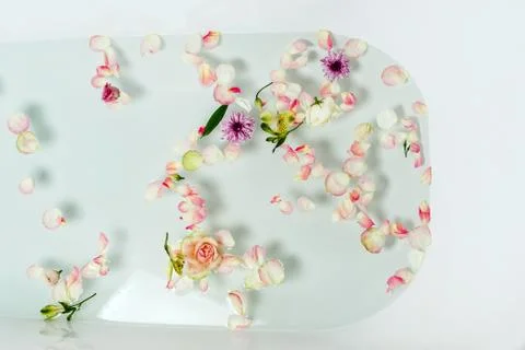 Top view of bath filled with bubble water, flowers and petals, spa or selfcar Stock Photos