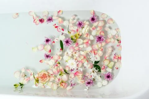 Top view of bath filled with bubble water, flowers and petals, spa or selfcar Stock Photos