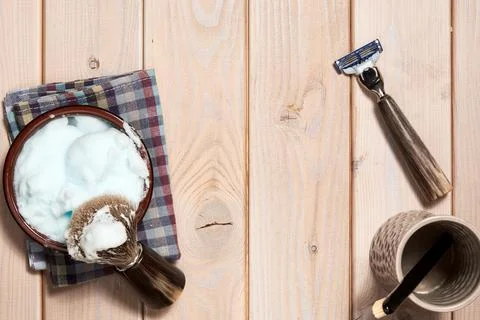 Top view of the bathroom table with razor, trimmer, brush, foam, towel Stock Photos