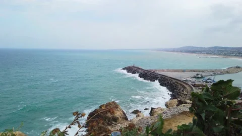 Top view. Bay. Lighthouse, pier. Cloudy, sky with white clouds. Stony seashore. Stock Footage 137960968