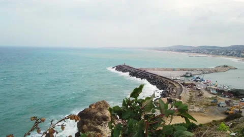 Top view. Bay. Lighthouse, pier. Cloudy, sky with white clouds. Stony seashore. Stock Footage 137960972