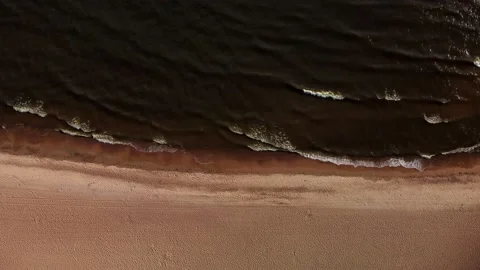 Top view of the beach and the sea in brown tones. aerial view of a secluded Stock Footage 160165451