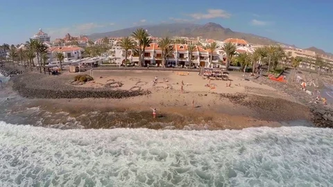 Top view of the beach with hotels and the ocean. Girl rejoices and greets the Stock Footage 77646992