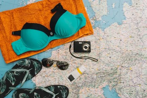 Top view beach objects. swimming costume, flip-flops, sunglasses and compact Stock Photos