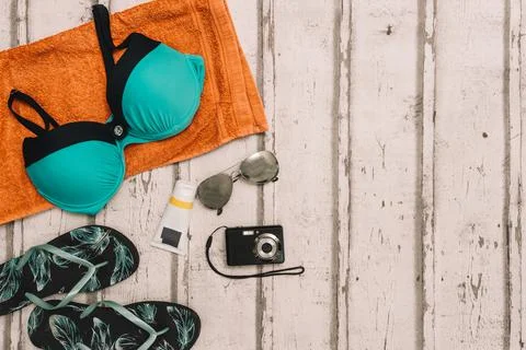 Top view beach objects. swimming costume, flip-flops, sunglasses and compact Stock Photos