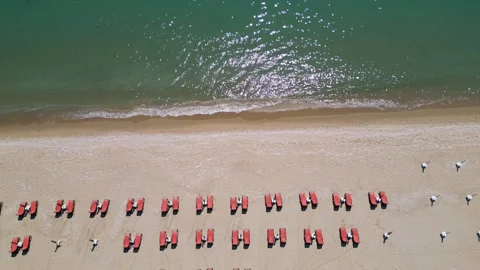 Top view of beach with red sunbeds and turquoise sea Stock Footage 336948848