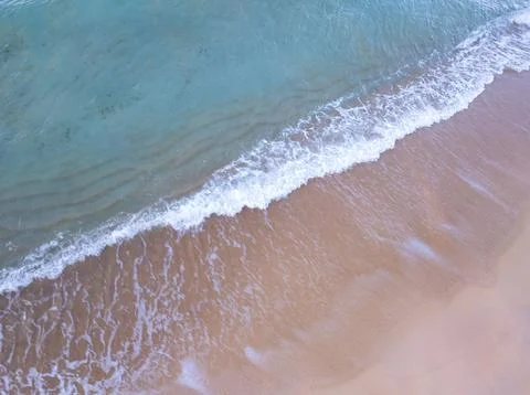 Top view beach with waves crashing on sandy shore,Beautiful waves sea surfa.. Stock Photos