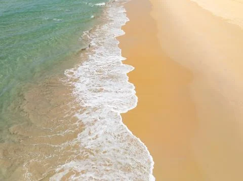 Top view beach with waves crashing on sandy shore,Beautiful waves sea surfa.. Stock Photos