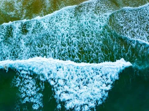 Top view beach with waves crashing on sandy shore Beautiful waves sea surfa.. Stock Photos