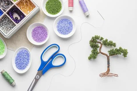 Top view bead working essentials with scissors tree Stock Photos