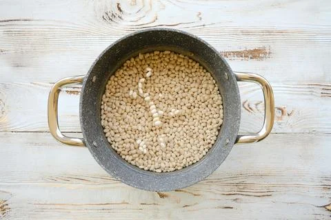 Top view of beans soaking in a casserole of water Stock Photos
