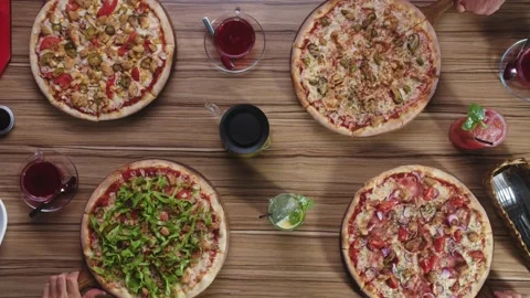 Top view of beautiful 4 pizzas on large wooden table Stock Footage 149093989